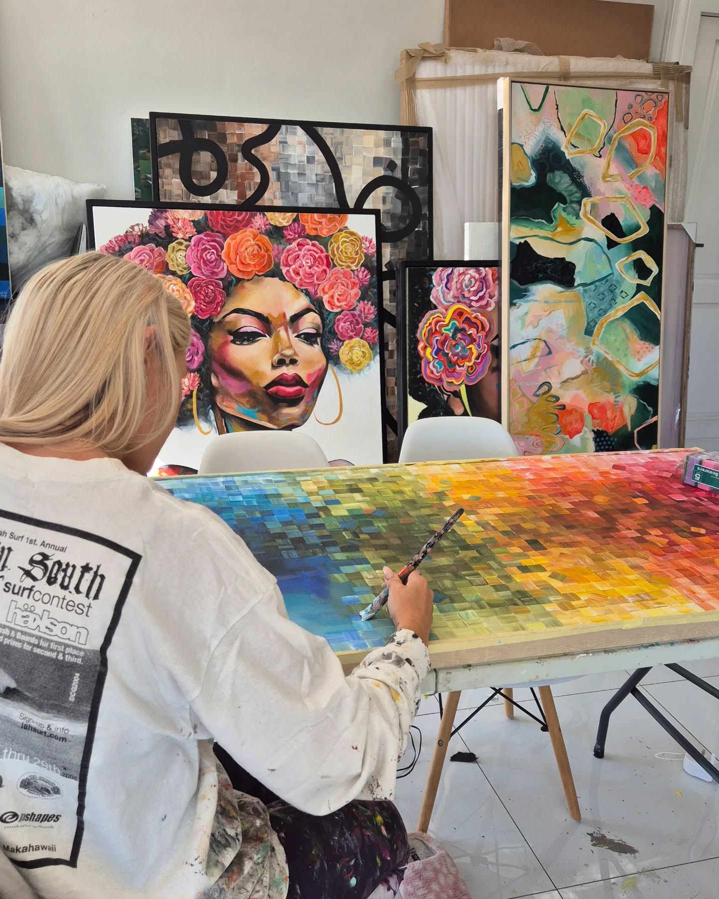Natalie Grey painting a piece of artwork